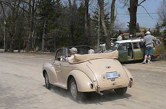 the tan convertible is a Morris Minor 1000 split windscreen... with swing-out turn signal flag