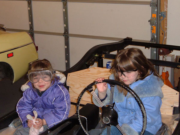 Who can resist a photo of little kids playing in a dissassembled British car?