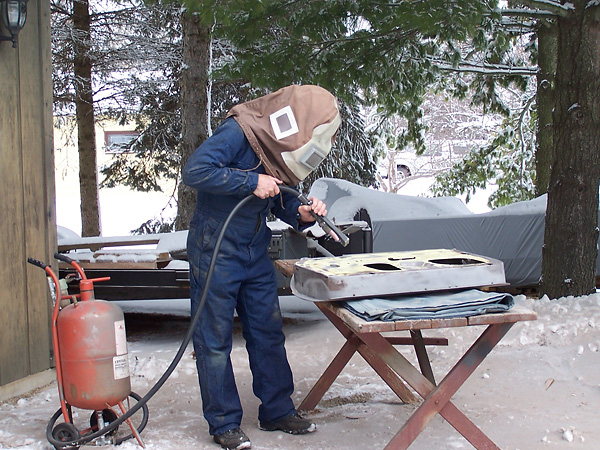 Sandblasting media piling up deep in the yard.