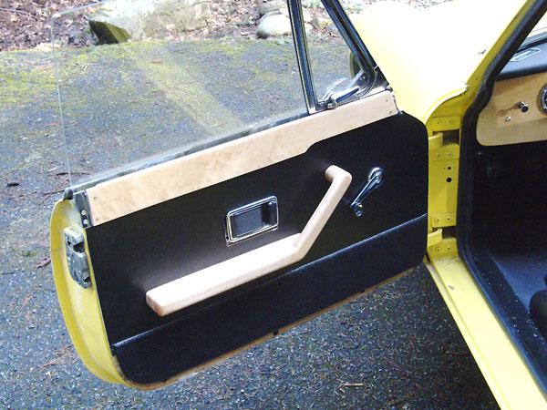 Custom door panels with birds-eye maple arm rests and caps.