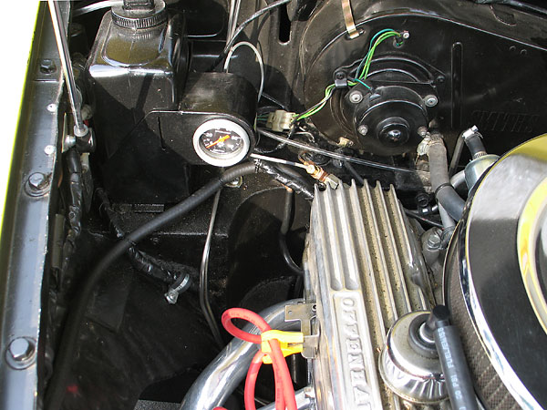 An AutoMeter oil pressure gauge has been incorporated into the windshield washer box. 