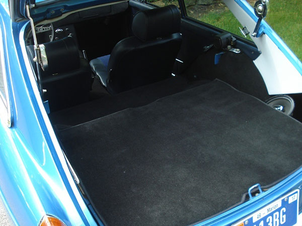 This shelf lifts up to reveal the spare tire and additional storage.