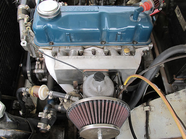 Custom intake manifold. Single S.U. HS6 carburetor. K&N gauze air filter.