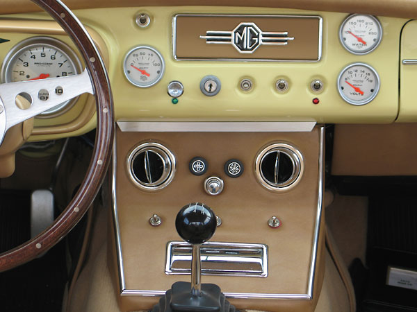 Custom built center console includes air conditioning controls and louvers.