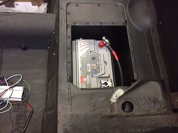 Single Yuasa 12V battery, mounted passenger side on specially fabricated bracketry.