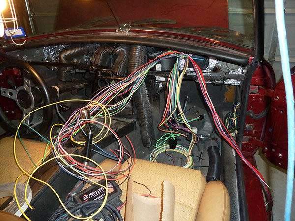 Beginning installation of an EZ Wiring 21-circuit Mini wire harness.