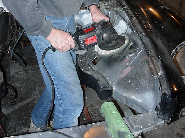 Buffing out the aluminum paneled engine compartment.