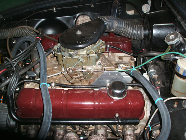 MGB coolant header tank has been relocated to high on the engine compartment bulkhead.