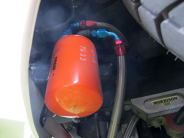 Fram Racing oil filter, mounted remotely behind drivers-side headlight.