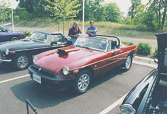 Craig Jenson's 78 MGB. 1964.5 Chevrolet 327, 350hp. 600 Edelbrock carb w/ Mechanical secondaries. Hooker box of parts headers through inner fenders. 3sp Saginaw transmission with HTOB. MGB axle. MGB radiator re-cored longer/4-core (runs cool - 173 degrees on hot days). hood scoop. fiberglass headers wrap. 8 spoke wheels. stock suspension except extra leaf in rear. roll hoop. Autometer gages