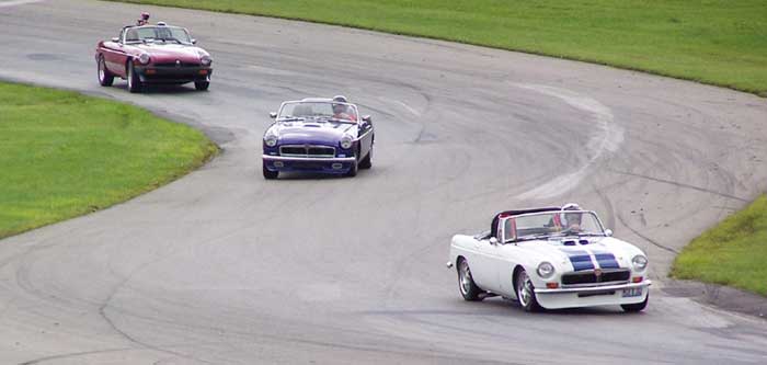 Carl Floyd's red 79 MGB, Mike Moor's blue 73 MGB, and Pete Mantell's white 69 MGB