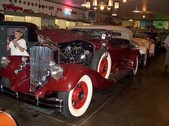 Mary Schils inspects a Rolls Royce in Frank Kleptz's collection