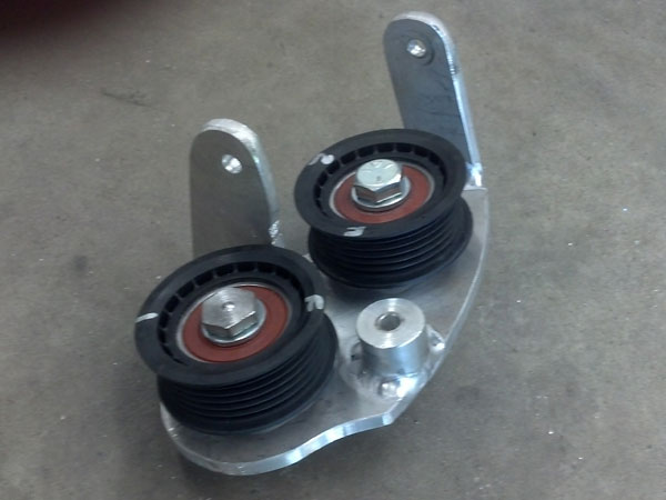 Custom fabricated pulley assembly in lieu of the AC compressor.