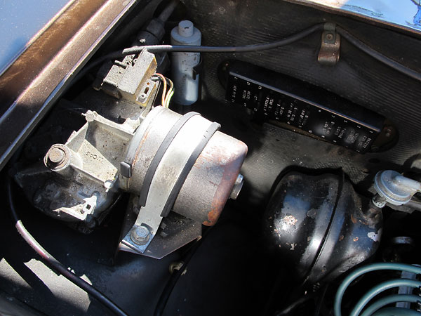 Clockwise from left: wiper motor, inertia switch, fuse block, and vacuum reservoir.