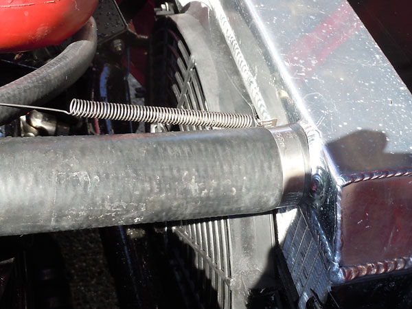 An electric fan pulls air through an (early model Ford Mustang size) aluminum radiator.