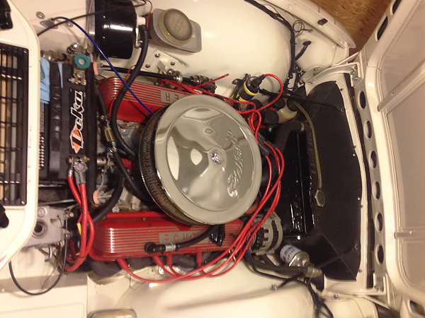 Edelbrock intake manifold, four barrel carburetor, and air cleaner.